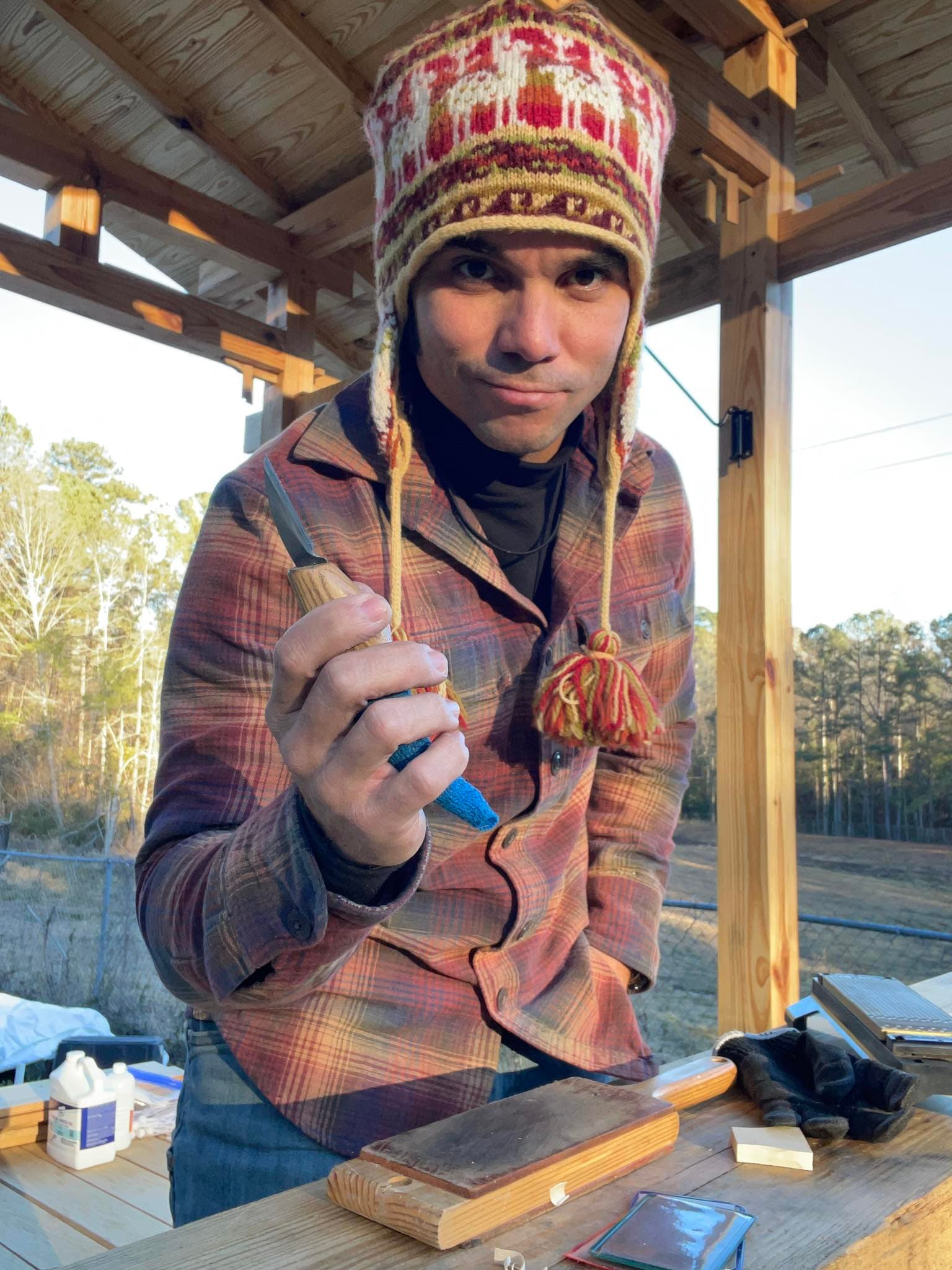 Wood carving workspace with carved wooden pieces and stencils